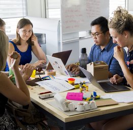 students gathered around table