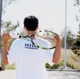 student holding tennis racket