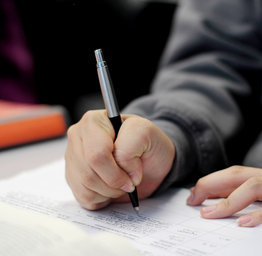 shot of hand writing in notebook